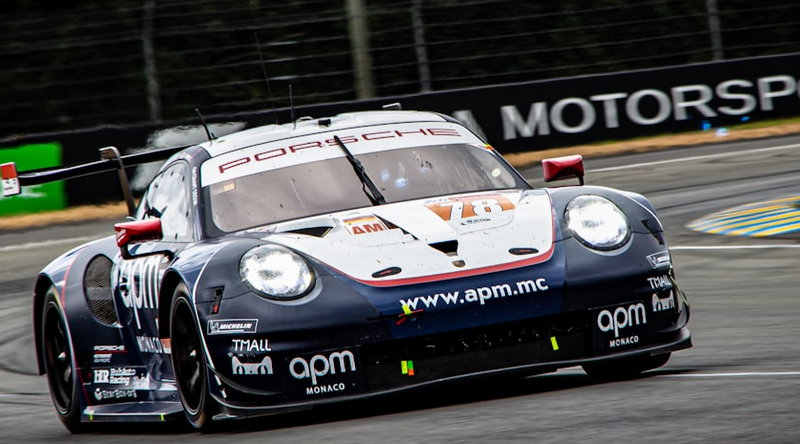 A blue and white race car on race track.