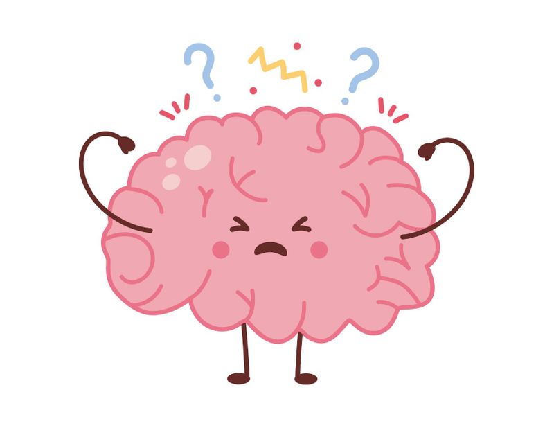 A cartoon brain with strained expression. Question marks float above its head.