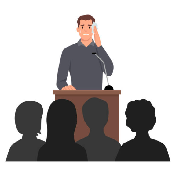A person giving a presentation in front of people wiping their face and looking nervous.