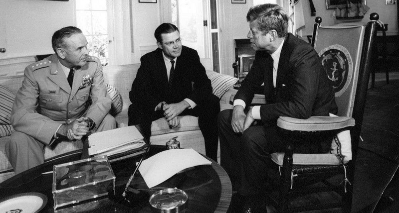 President Kennedy meets with advisors in the Oval Office.