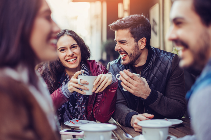 A man and woman enjoying coffee at a cafe.