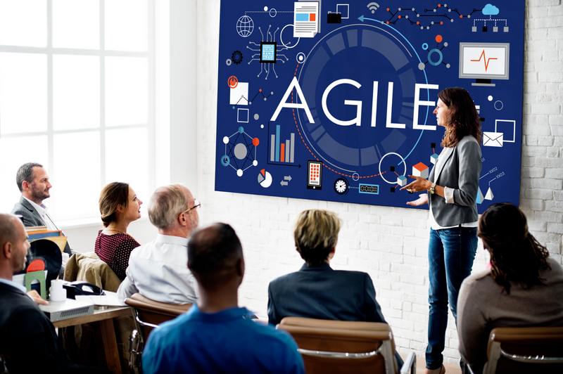 A woman presenting about Agile at a conference.