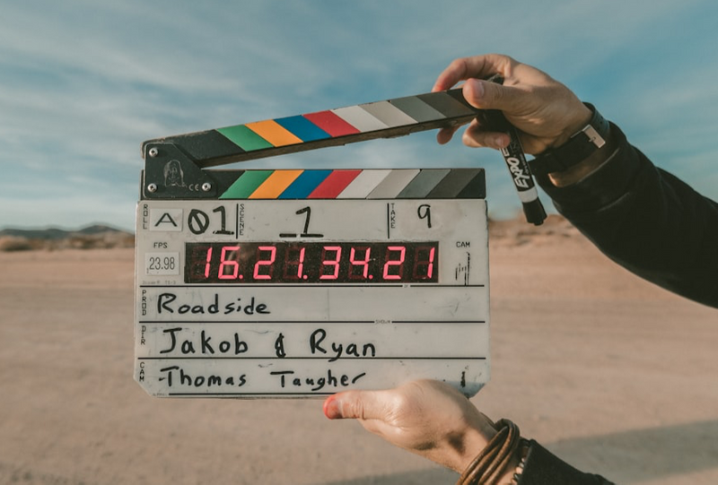 Image of two hands holding a clapperboard representing next scene.