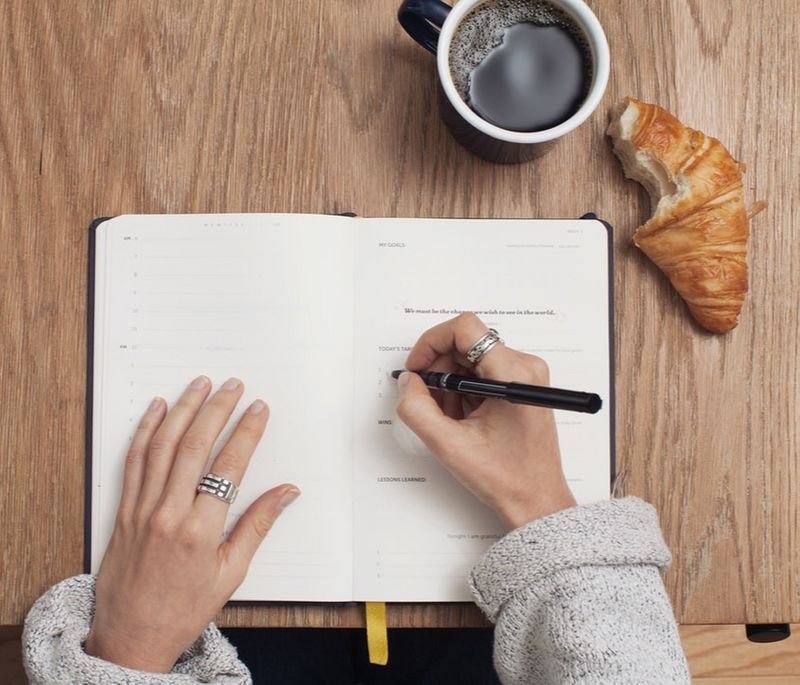 A person writing in a journal