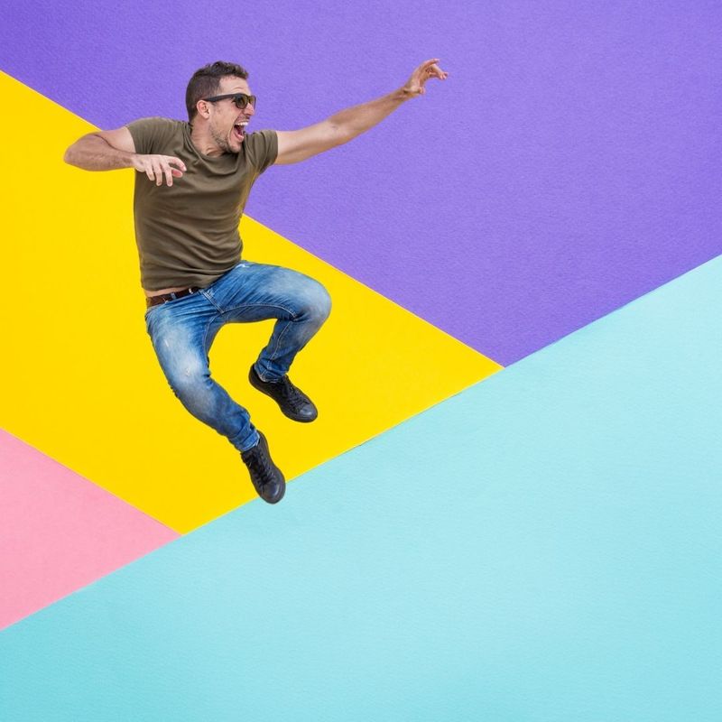 Man jumping above a colorful background