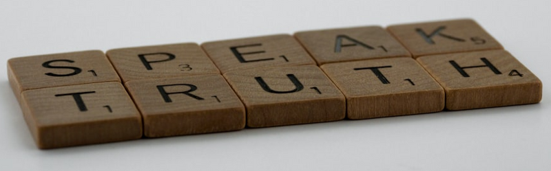 A series of Scrabble tiles that read 'speak truth'.