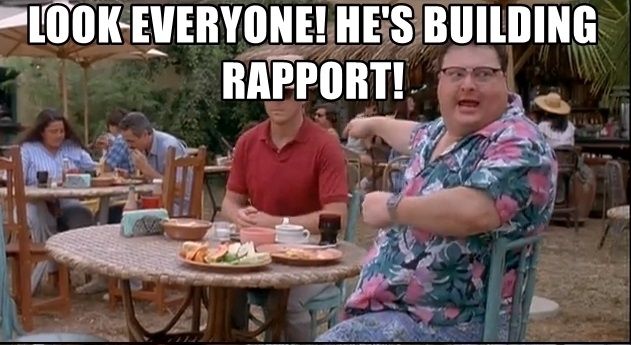 Newman (Sienfeld)  points to a guy sitting on a table next to him. Underlying text: Look everyone! he's building a rapport!