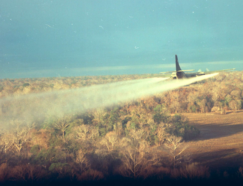 A US military plane dropping Agent Orange on a forest.