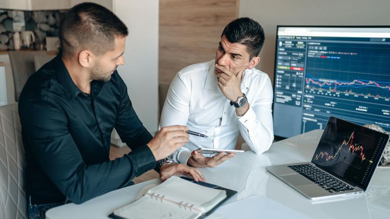 Two stock brokers having a discussion.