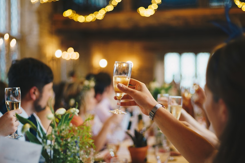 Toasting with glasses at a wedding reception