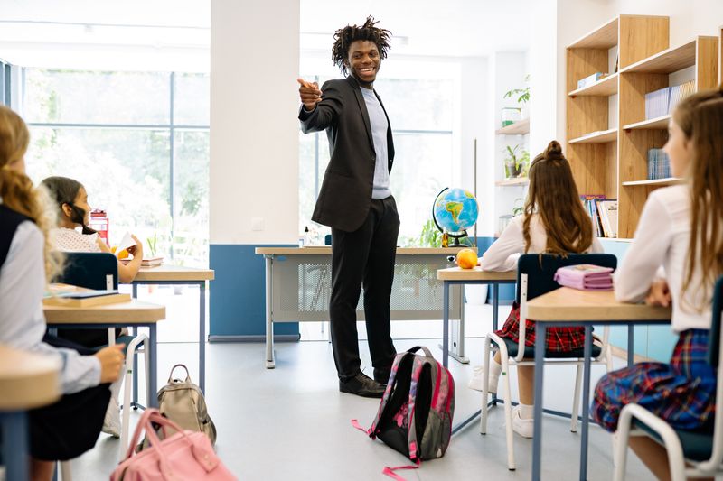 AmMale teacher in elementary school classroom.