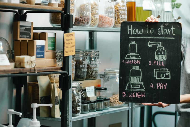 Image of a zero waste store with shelves containing products in eco-friendly packaging showing instructions on how to shop.