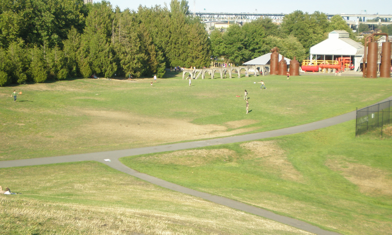 Gas Works Park Seattle Washington, open field with old factory buildings in background.