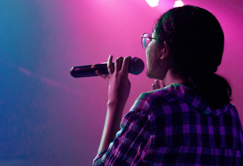 Person singing into a microphone
