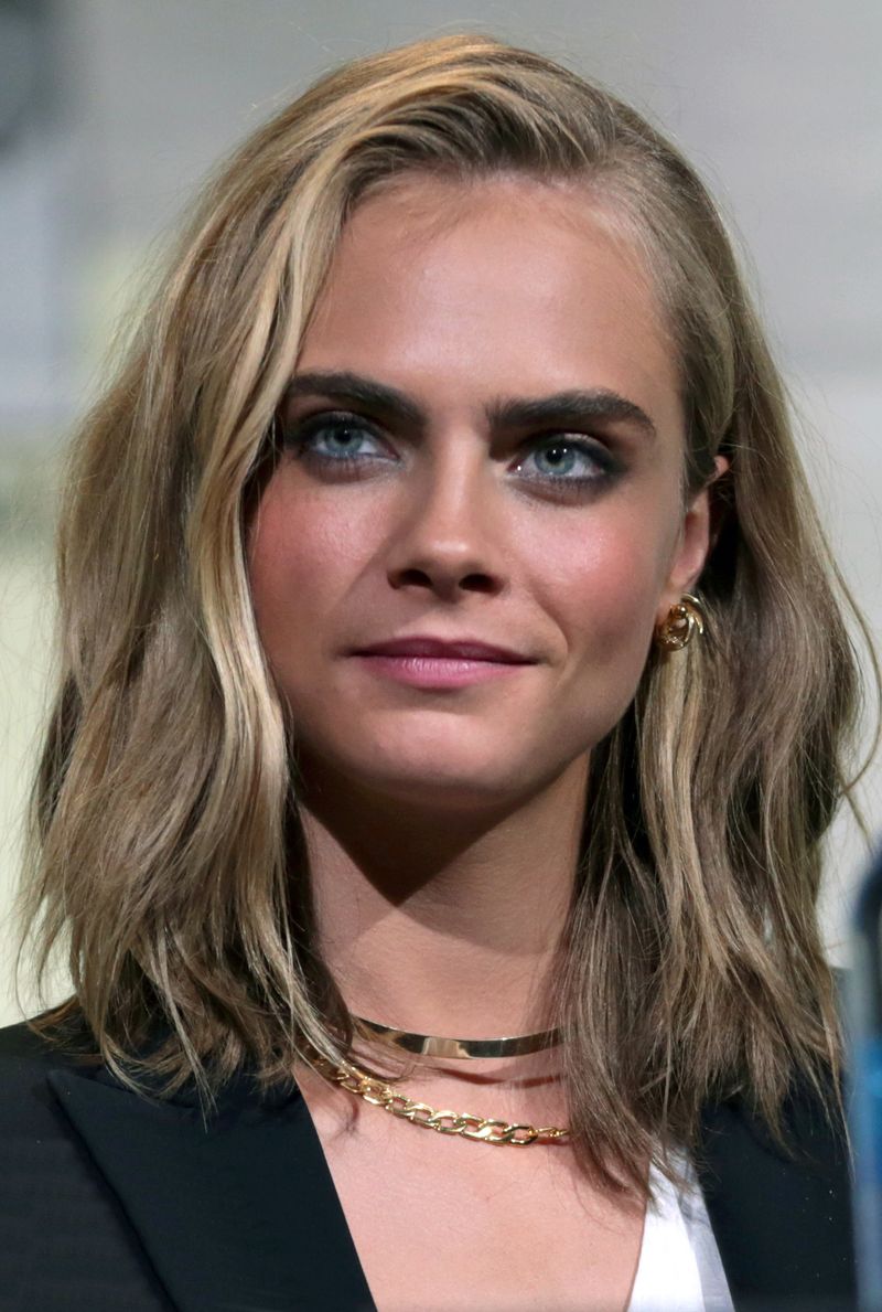 Cara Delevigne posing for cameras.