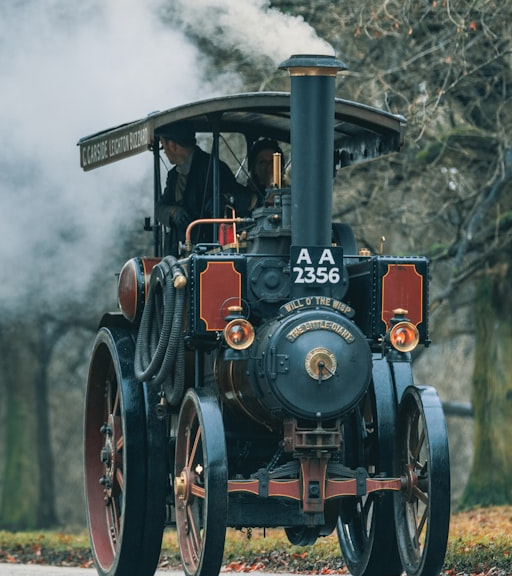 A steam engine car on a road.