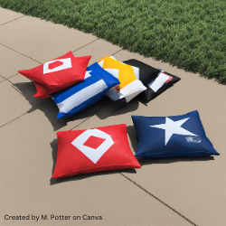 Bean bags on the ground by a grassy area.