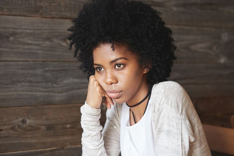 Young African-American woman sitting in cafe