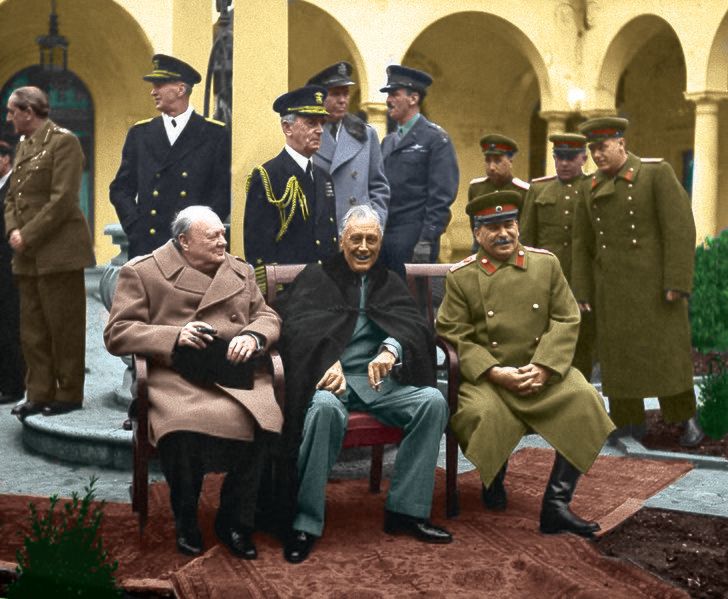 A color photo of Churchill, Stalin, and Roosevelt meeting at Yalta.