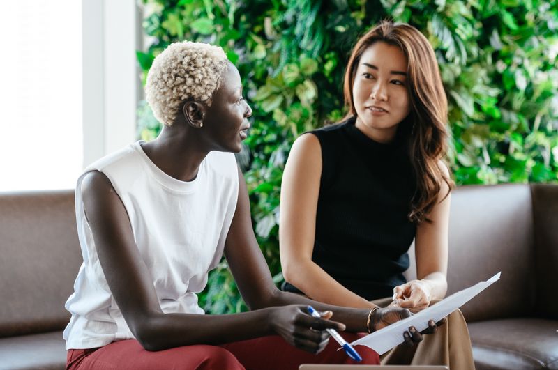 Two women discussing the meeting in a followup conversation. 