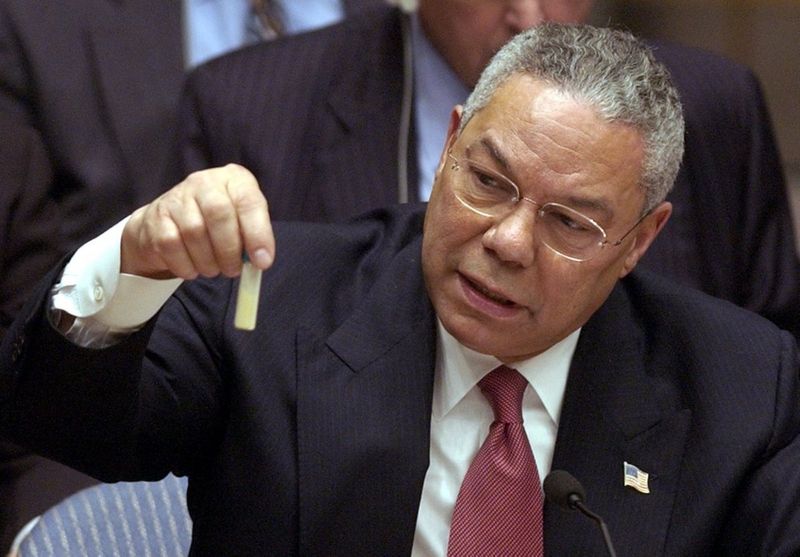 Colin Powell displaying yellow cake uranium in a vial at the UN.