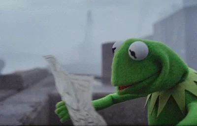 Kermit the Frog  looks confused with an opened map as he doesn't know which direction to go.