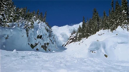 An avalanche falling down a mountain.
