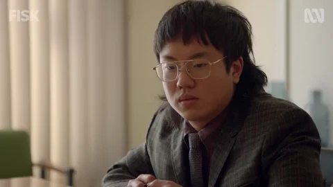 A person looking puzzled at their work desk.