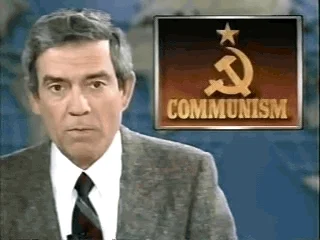 Newscaster Dan Rather speaks on TV with a logo of a hammer and sickle on a graphic beside him.