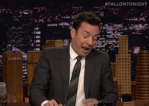 Jimmy Fallon shrugging his shoulders in acceptance.