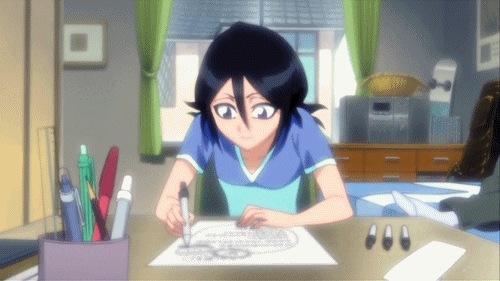 Girl sitting at a desk in her bedroom drawing
