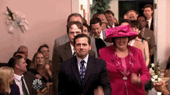 Characters on TV show The Office perform a choregraphed dance down the aisle at a wedding.
