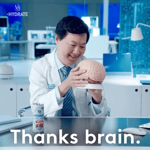 GIF of doctor kissing a model of a brain. Text overlay reads 'Thanks brain'