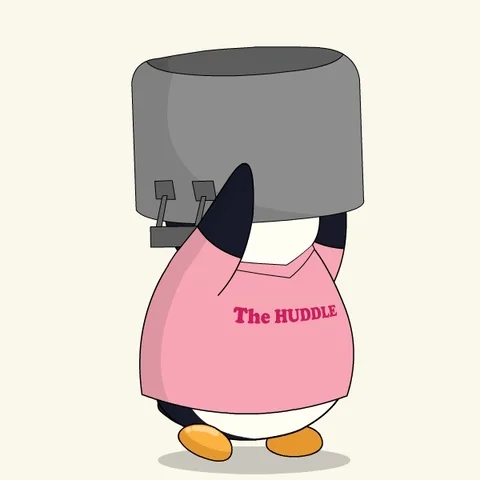 A penguin in a pink shirt walks with a large pot covering its head.