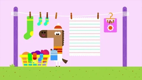 Laundry falling on a cartoon horse.