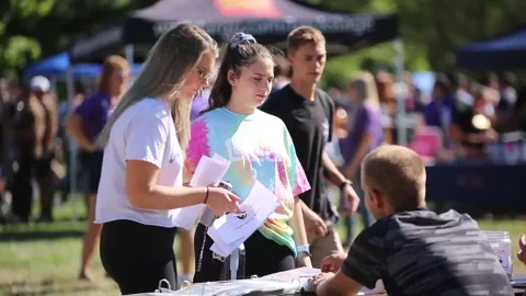 College students joining clubs at a student organization fair.