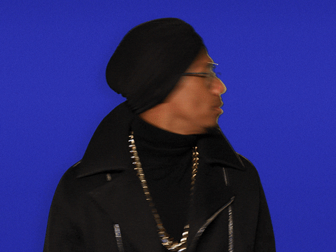 GIF of Nick Cannon looking confused and pointing to himself.