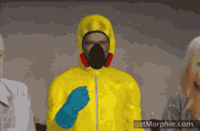 A man in a biohazard suit throwing confetti
