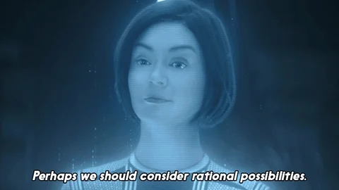 A woman with bobbed hair is seen through a blue filter. She is saying, 