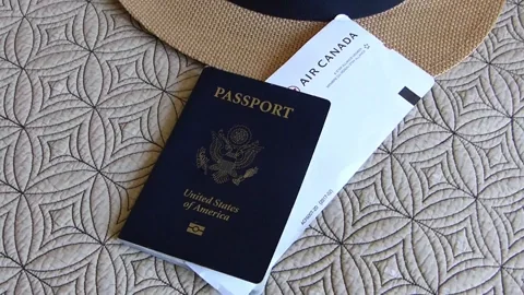 Man packing his bag and grabbing his passport and boarding pass