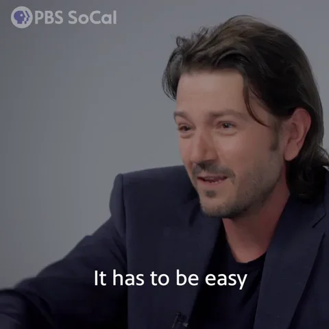 A man smiles and says, 