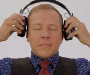 A man putting on headphones at the end of his habit loop.