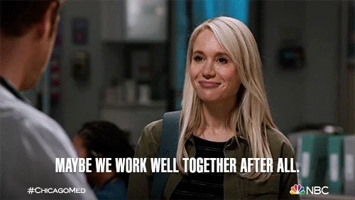 A woman saying to her colleague, "Maybe we work well together after all."