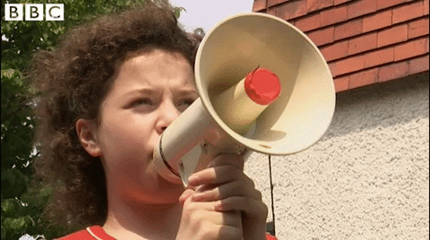 Woman using megaphone overlaid with text 'Attention Please'