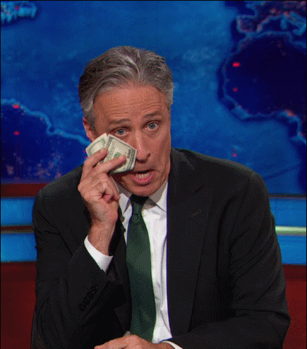 John Stewart drying tears off his face with dollar bills