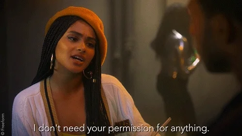 A girl with long black hair, hoop earrings, and an orange beret says, 'I don't need your permission for anything.'