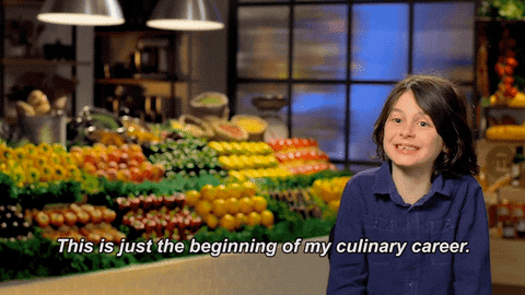 A child sitting in front of a produce section saying, 'This is just the beginning of my culinary career.'