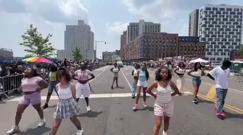 A group of people dancing during a street parade.