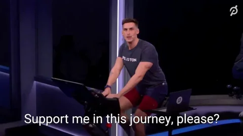 A spin class instructor cycling and saying, 'Support me in this journey, please?'