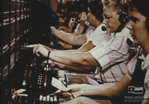 Switchboard operators plugging in cables